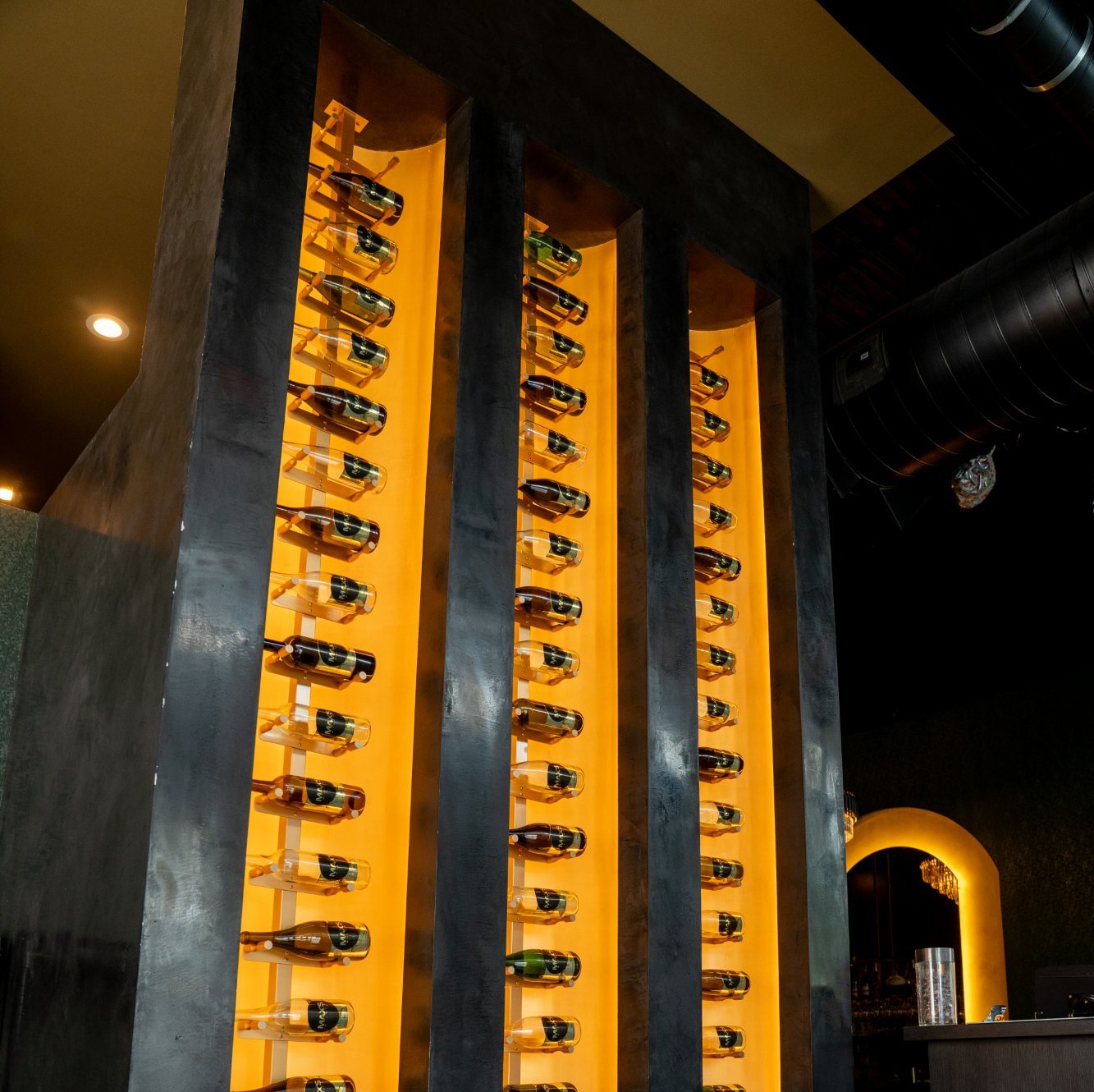 Backlit shelves of wine bottles in the wine room